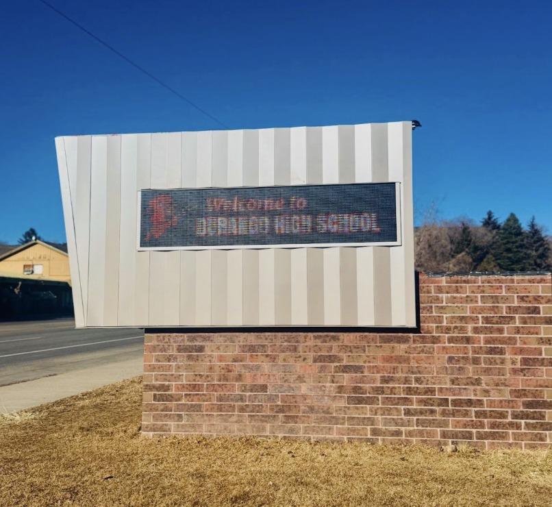 The new sign out front of the highschool, along the highway.